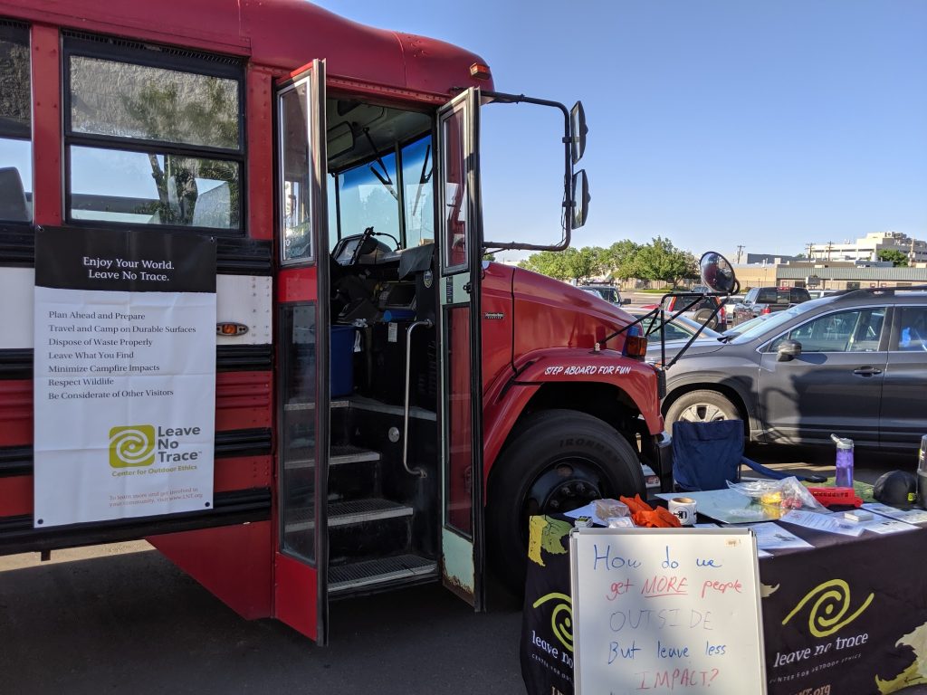 The bus set up for a Leave No Trace session, with the seven principles displayed beside an outdoor teaching table