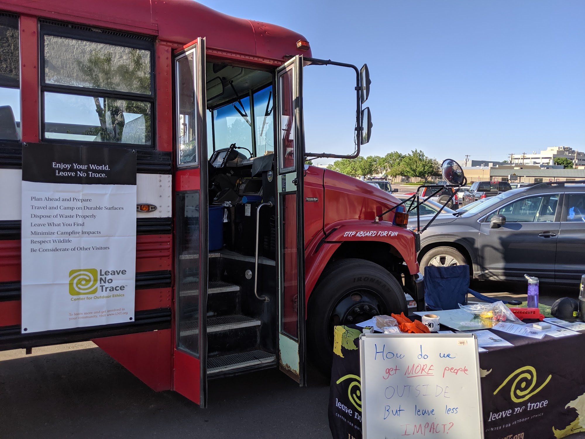 The bus set up for a Leave No Trace session, with the seven principles displayed beside an outdoor teaching table
