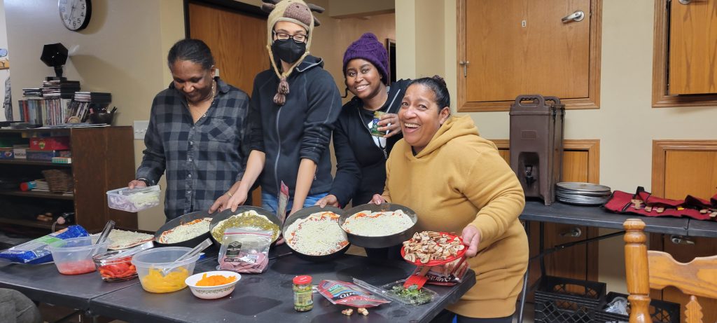 Outdoor Afro participants preparing a meal together in a camp kitchen